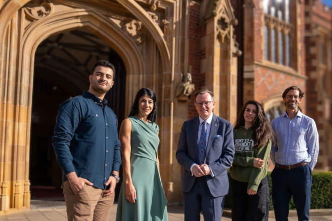 Diverse group of five people standing in front of the Lanyon building