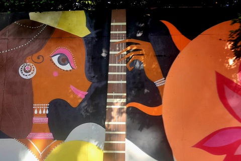 Wall art of woman playing guitar in Belfast