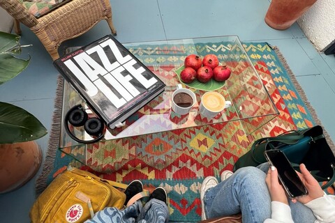 Table with a book and coffee on top in Blue Train Cafe