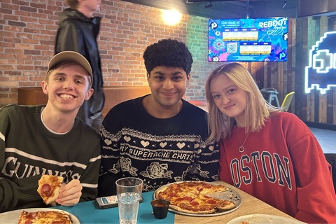 Three students sitting at table in Reboot cafe