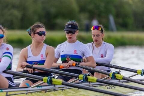 Three students rowing