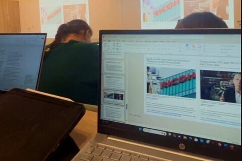 Student's laptop on top of table in Business lecture
