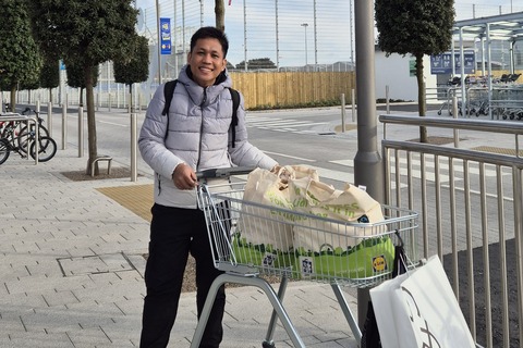 Student Muhammad with trolley full of groceries from Lidl