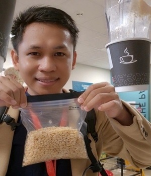 Student Muhammad picks up cereal in the QUB Pantry