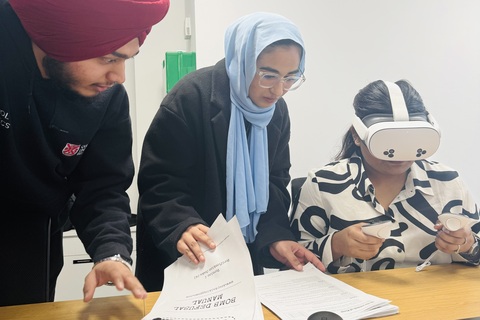 Three students using a VR headset