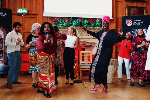 Group of people dancing at QUB sanctuary event