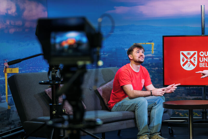 Queen's student in front of camera
