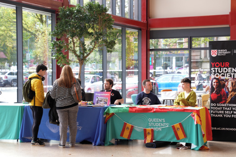 Staff at tables in Queen's SU