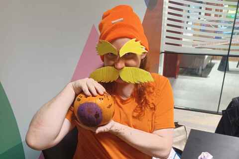 Member of Scream Queen's Society painting a pumpkin