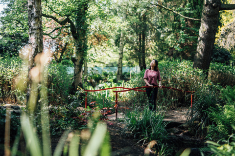Student standing on bridge in Botanic Gardens