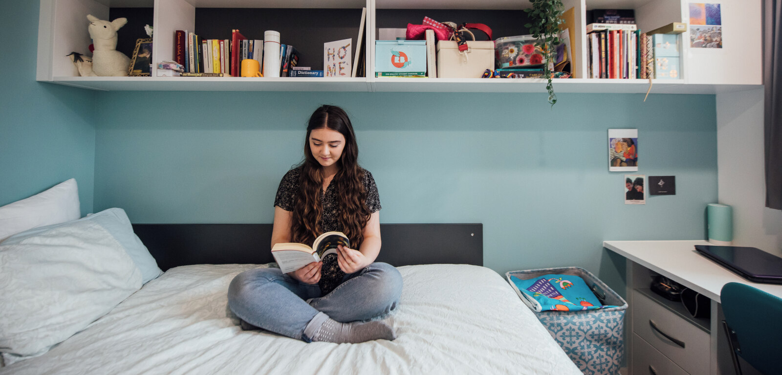 Student reading on bed in accommodation