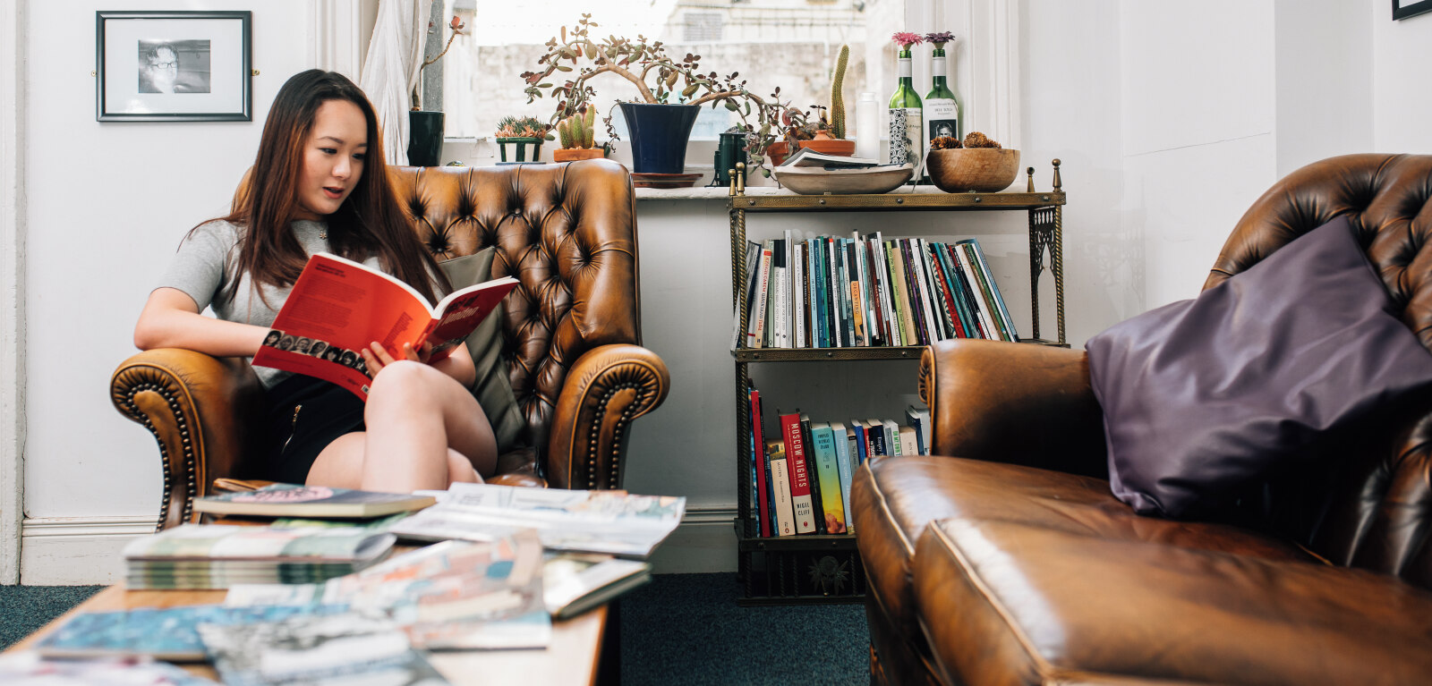 Student reading book in Queen's School of English