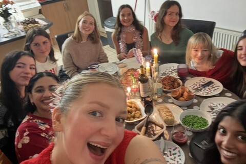 Student Tash and friends sitting down for dinner