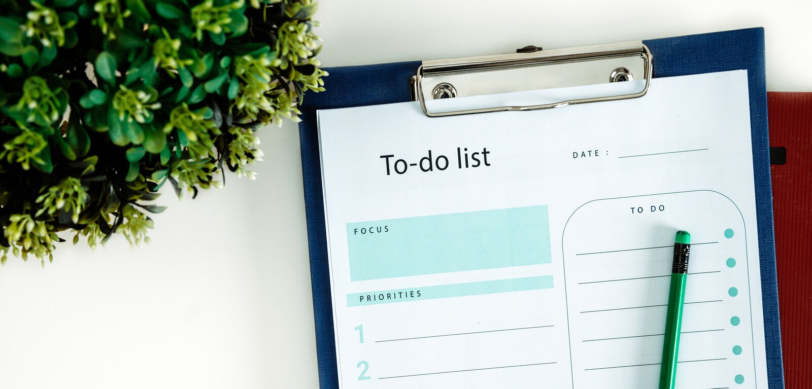 To do list on clipboard on top of table
