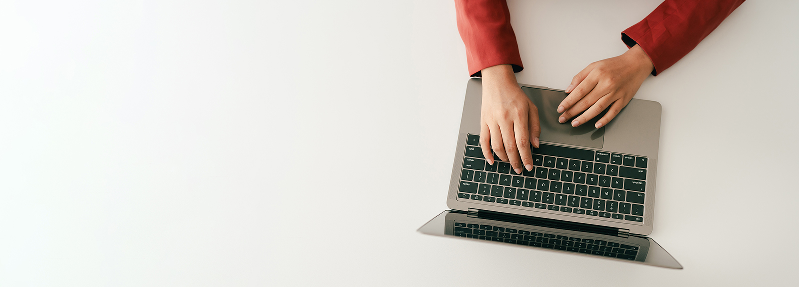 A student typing on a laptop computer