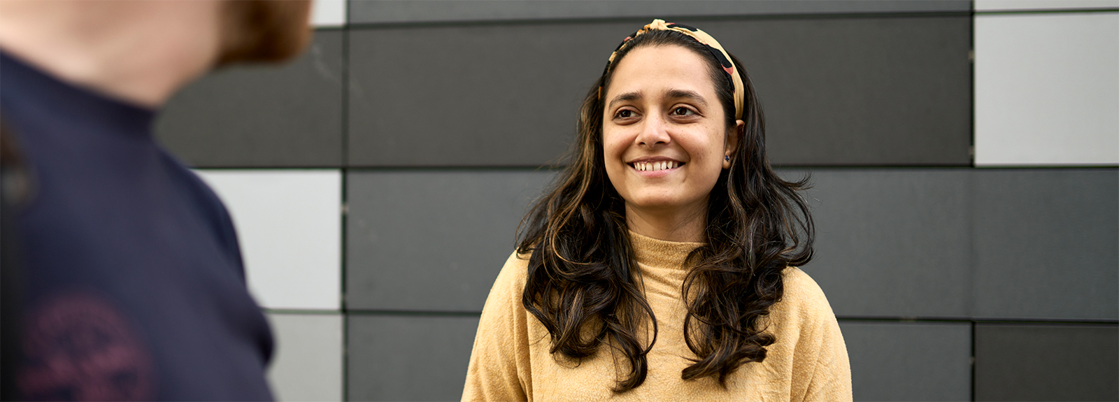 A PhD student smiling at the camera
